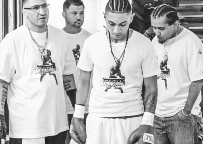 Boxing athlete with trainers looking down before training